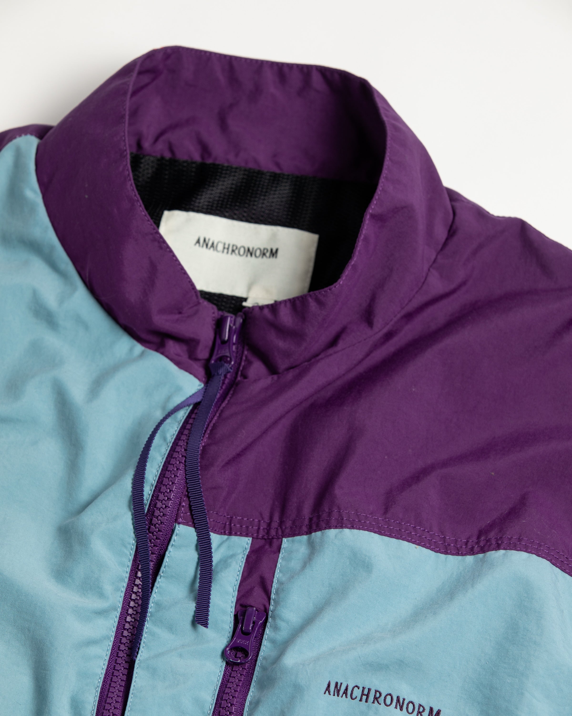 ANACHRONORM / EXCHANGE PATTERN NYLON JACKET - SKY BLUE×PURPLE